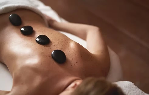 Heated stones placed along the spine during hot stone massage at Massage by Laura, Runaway Bay